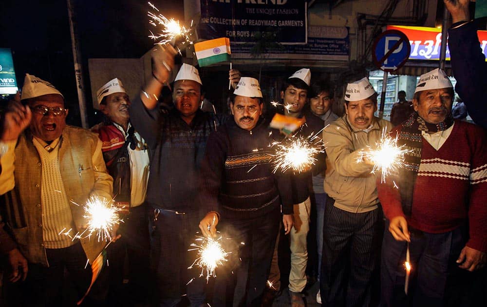 Indian supporters of the Aam Aadmi Party (AAP), or Common Man’s Party, celebrate with firecrackers in Ahmedabad.