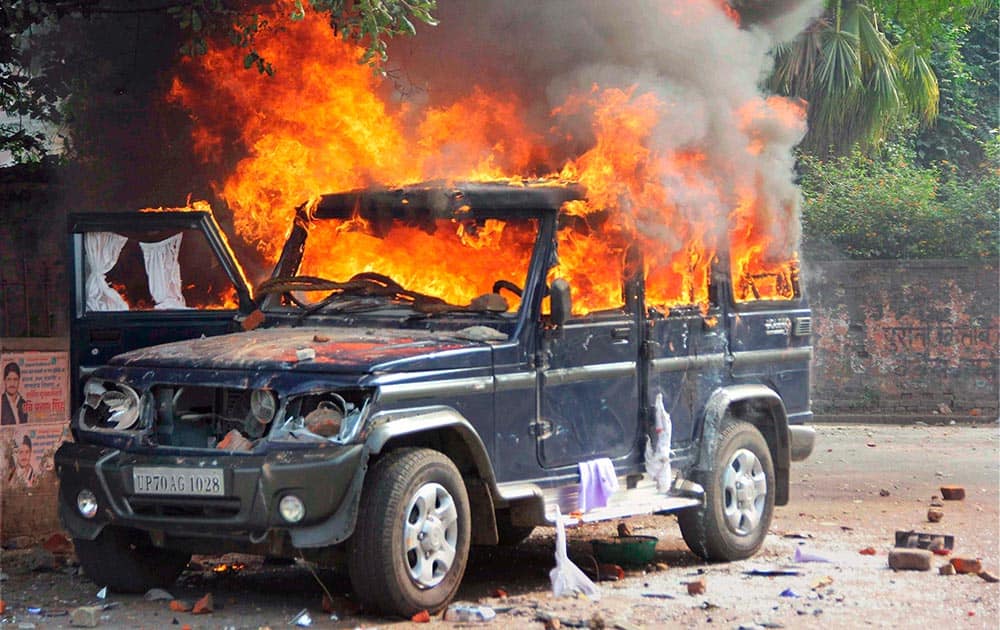 A police vehicle set on fire by protesters demanding CBI investigation against corruption in the Lok Seva Ayog recruitment, in Allahabad.