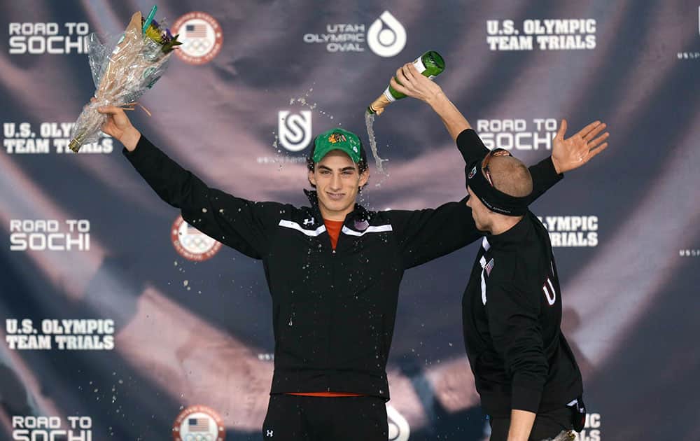 Winner Emery Lehman, left, celebrates with third-place finisher Patrick Meek, right, on the podium following the men`s 10,000 meters during the U.S. Olympic speedskating trials, in Kearns, Utah.