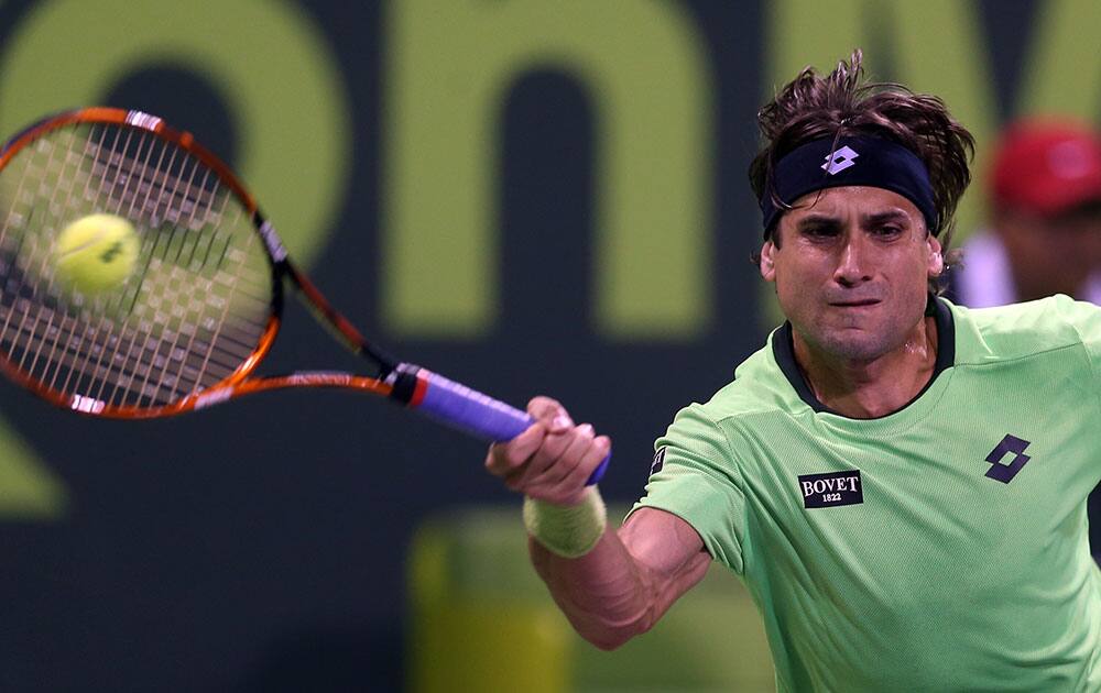 David Ferrer of Spain returns the ball to Daniel Brands of Germany during the Qatar ATP Open Tennis tournament in Doha, Qatar.