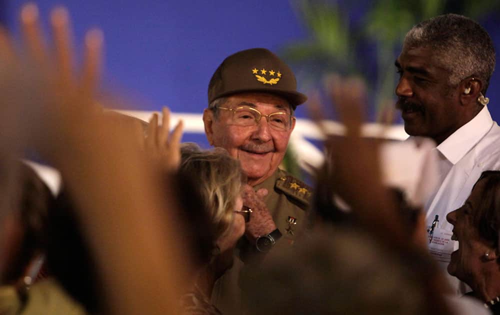 Cuba`s President Raul Castro greets people during the 55th anniversary celebration of the Cuban Revolution at the main plaza in Santiago, Cuba.