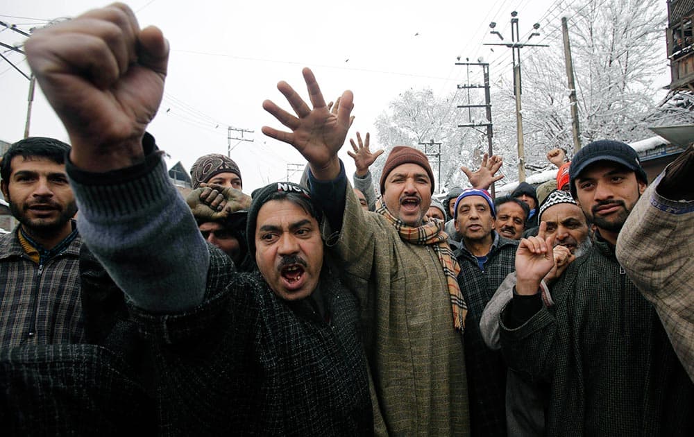 Kashmiri residents shout slogans against the state government and electric department as they block a road during a protest in Srinagar.