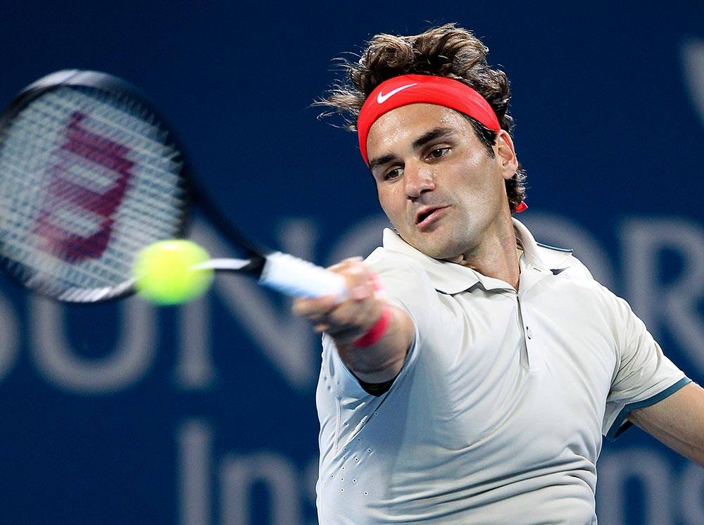 Roger Federer of Switzerland plays a shot in his match against Jarkko Nieminen from Finland during the Brisbane International tennis tournament in Brisbane, Australia.