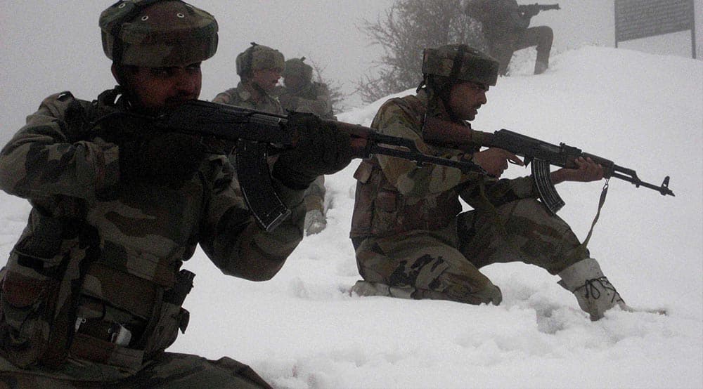 Army jawans keep vigil after the first major snowfall of the season in Poonch, Jammu & Kashmir.