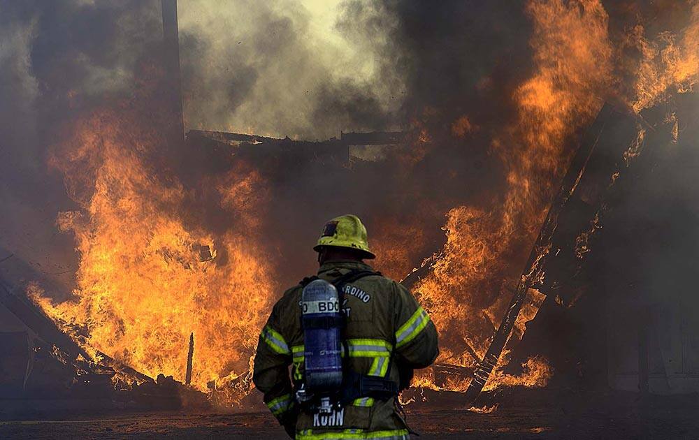 More than 20 fire units, from at least five agencies, fight a third-alarm fire, at an abandoned bowling alley, once known as the San-Hi Lanes, in San Bernardino, Calif.