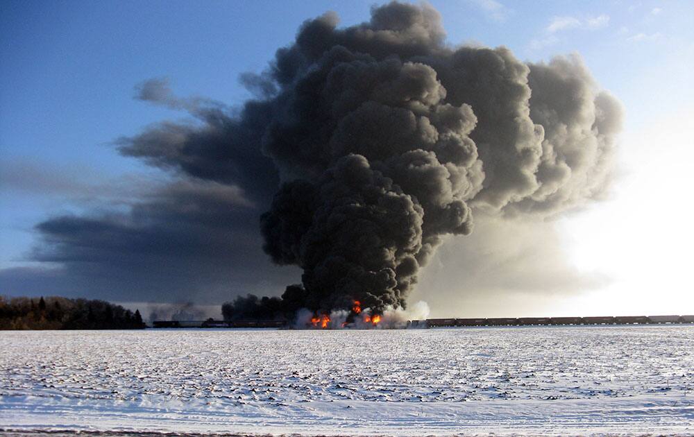 This photo provided by Cass County Commissioner Ken Pawluk shows a train derailment and fire west of Casselton, N.D. No one has been reported hurt in the derailment or fire. By late Monday afternoon, the smoke plume was diminishing and was staying mostly away from town.