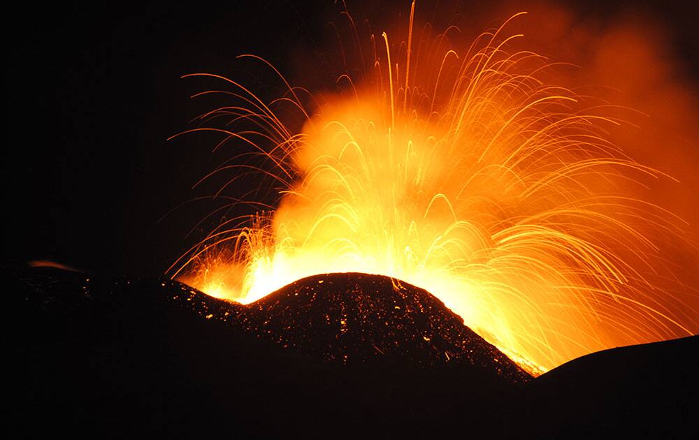 Lava spews from the South East Crater of Mt. Etna during an eruption, in Sicily, southern Italy.
