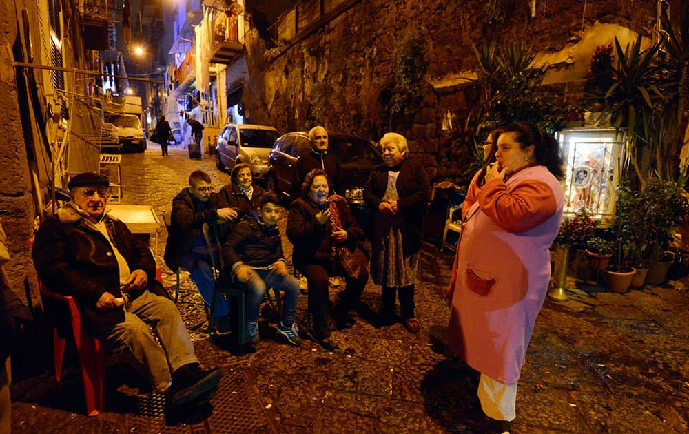 People sit in the street in Naples, Italy. Italy`s National Institute of Geophysics and Volcanology said an earthquake at 6:08 p.m. (1708 GMT) had a magnitude of 4.9 and struck some 10.5 kilometers (6.5 miles) underground.