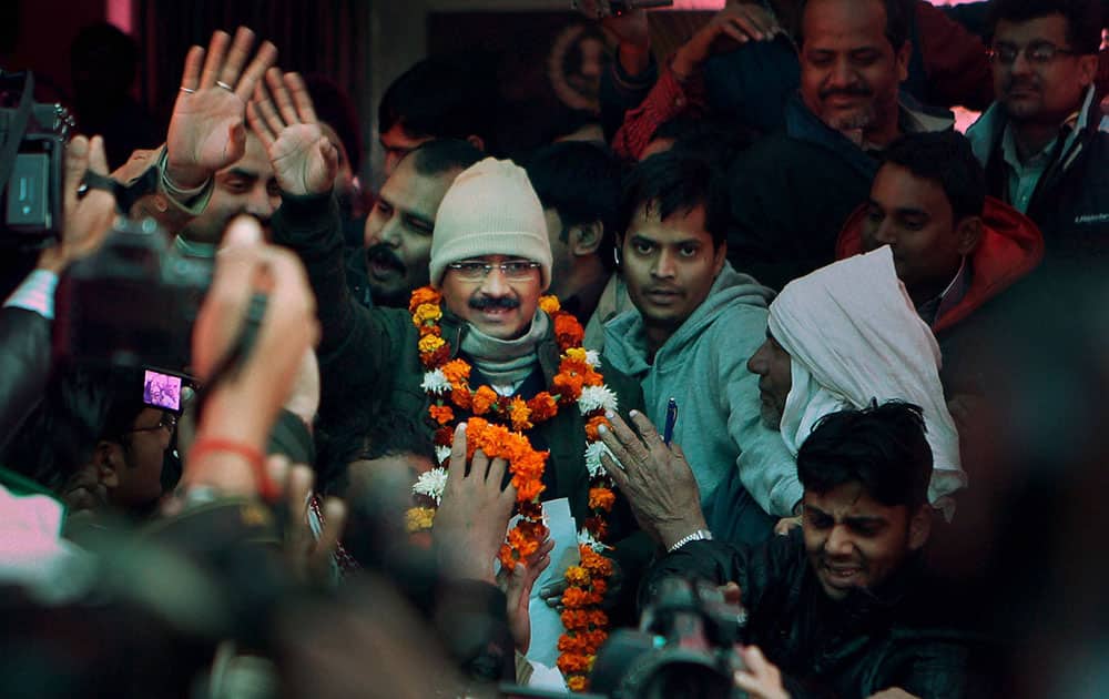 Aam Aadmi, or the Common Manâ??s Party leader Arvind Kejriwal, center, meets people outside his residence a day after he was sworn in as the Delhi state Chief Minister, in Kaushambi, Ghaziabad.