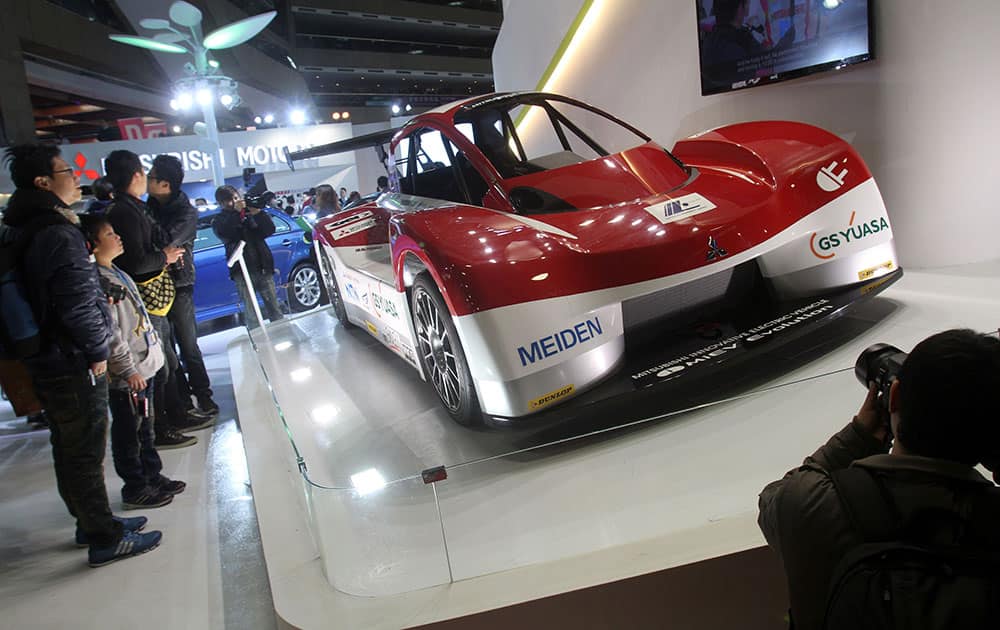Visitors look at i MiEV (Mitsubishi innovative Electric Vehicle) on display during the Taipei International Auto Show at the Taipei World Trade Center.