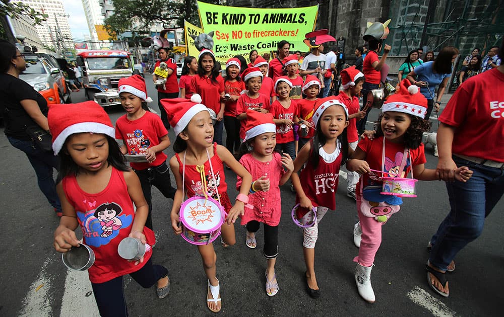 Filipino children play alternative noisemakers as they join a rally against firecrackers and fireworks during New Year revelries in Manila, Philippines.
