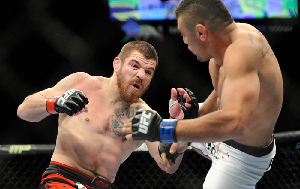 Jim Miller, left, of Whippany, N.Y., and Fabricio Camoes, of San Diego, Calif., battle during a UFC 168 mixed martial arts lightweight bout, in Las Vegas. Miller won by a tap out in the first round.