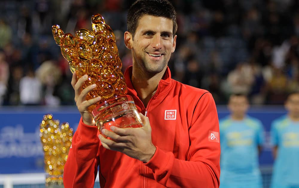 Novak Djokovic of Serbia holds the trophy after he beat David Ferrer of Spain during the final match of the Mubadala World Tennis Championship in Abu Dhabi, United Arab Emirates.