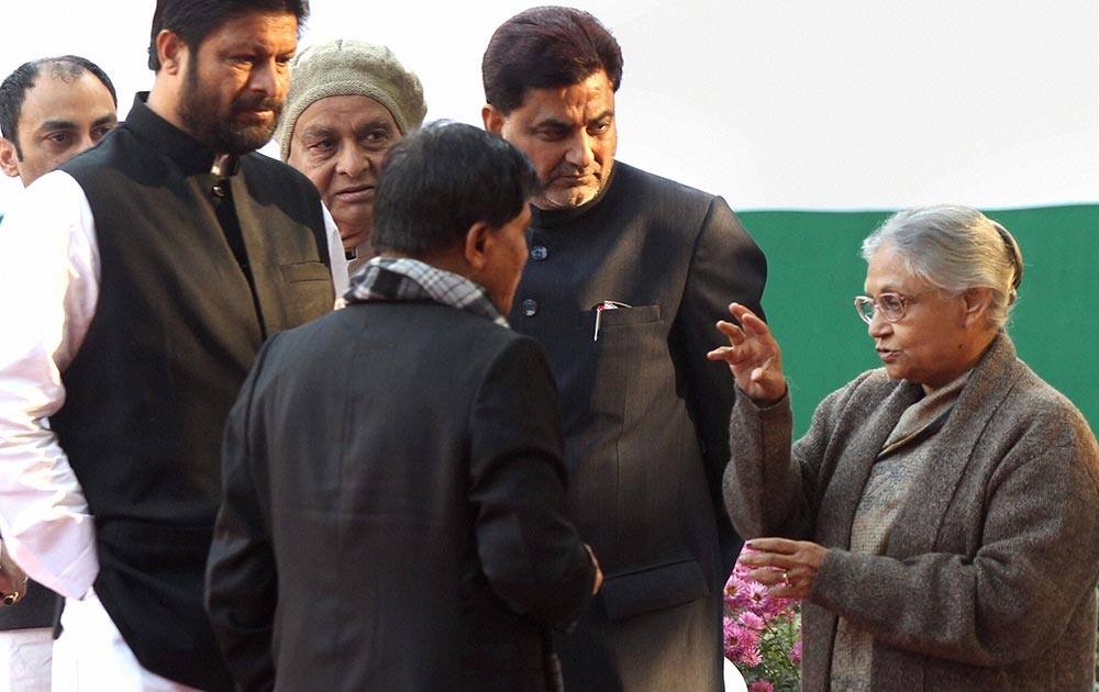 Former Chief Minister of Delhi Sheila Dikshit with party Delhi MLA Jaikishan during the Congress party`s 128th foundation day function at AICC Headquarters in New Delhi.