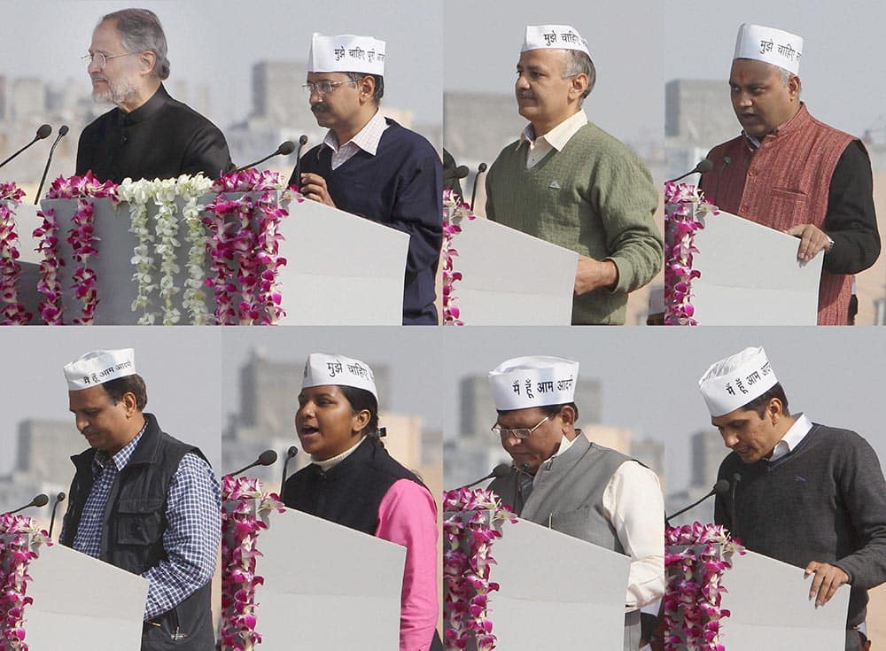 Lieutenant Governor Najeeb Jung administers the oath of office and secrecy to AAP convener Arvind Kejriwal as Delhi Chief Minister and party leaders Manish Sisodia, Somnath Bharti, Saurabh Bharadwaj, Girish Soni, Rakhi Birla and Satyendra Jain as cabinet ministers during the oath-taking ceremony at Ramlila maidan.