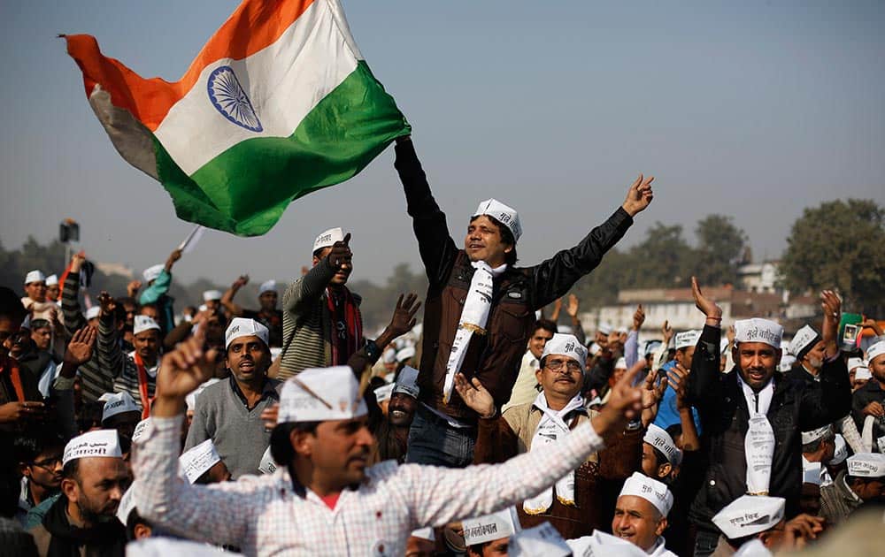 Supporters of Aam Aadmi Party, or Common Man`s Party, dance on patriotic songs while witnessing the swearing-in ceremony of party leaders in New Delhi.
