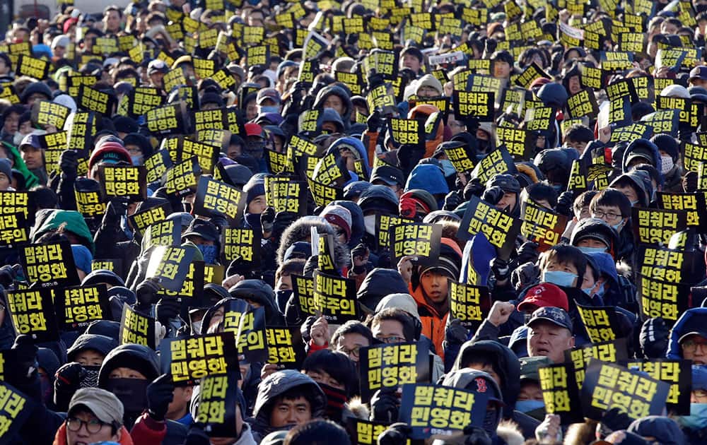 Workers from the Korea Railroad Corp. and supporters from the Korean Confederation of Trade Union shout slogans during a rally against government policy in Seoul, South Korea.