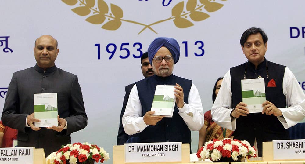 Prime Minister Manmohan Singh with HRD Minister M M Pallam Raju and MoS for HRD Shashi Tharoor release of the book.
