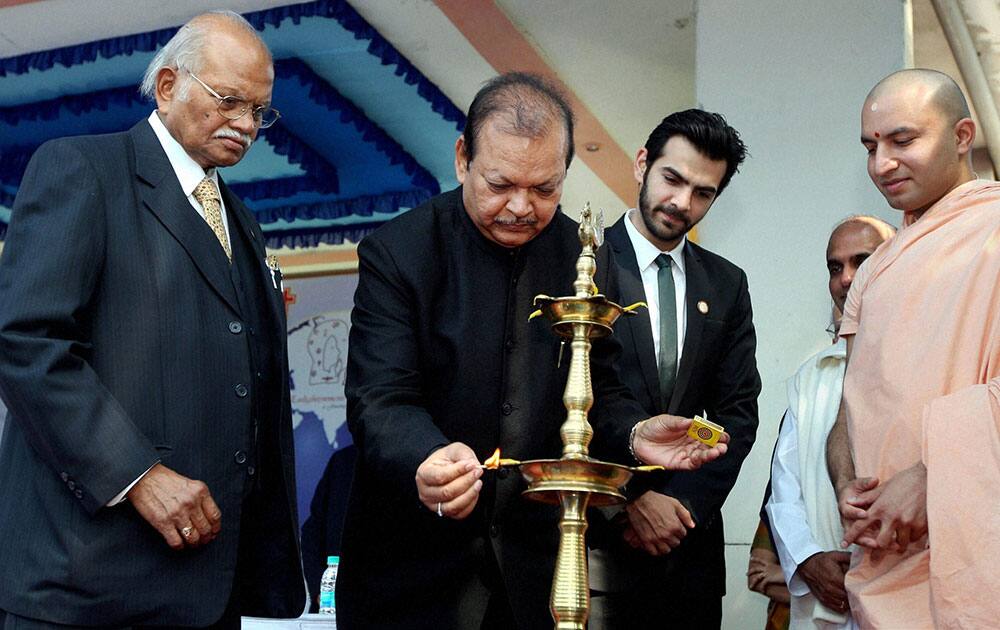 Former Union Tourism Minister Subodh Kant Sahay lights the lamp to inaugurate the 5th World Confluence of Humanity, Power and Spirituality in Kolkata.