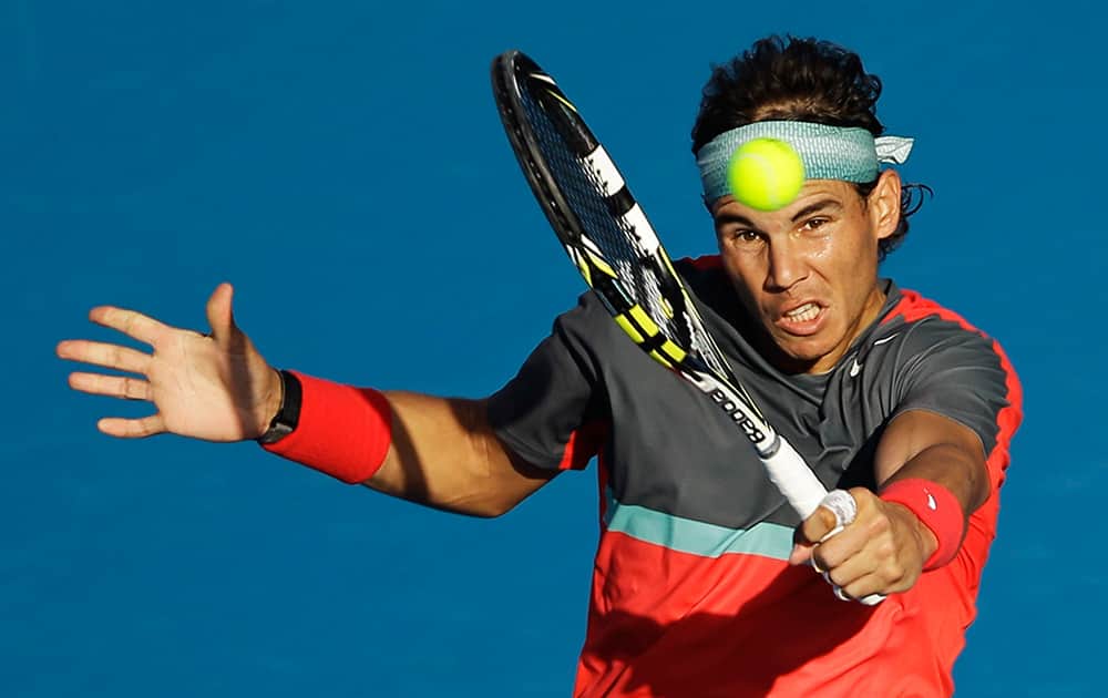 Rafael Nadal of Spain returns the ball to his fellow countryman David Ferrer during the second day of the Mubadala World Tennis Championship in Abu Dhabi, United Arab Emirates.