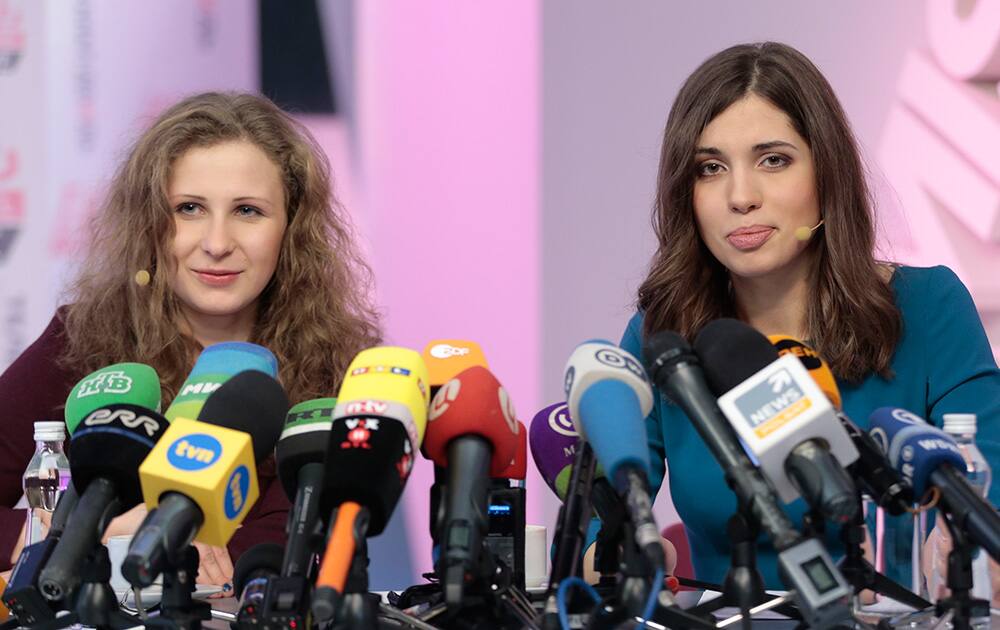 Russian punk band Pussy Riot members Nadezhda Tolokonnikova, right, and Maria Alekhina smile during their news conference in Moscow, Russia. Tolokonnikova and Alekhina were granted amnesty on Monday, Dec. 23, two months short of their scheduled release after spending nearly two years in prison for their protest at Moscow`s main cathedral.