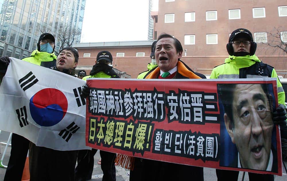 Protesters shout slogans against Japanese Prime Minister Shinzo Abe in front of Japanese Embassy in Seoul, South Korea.