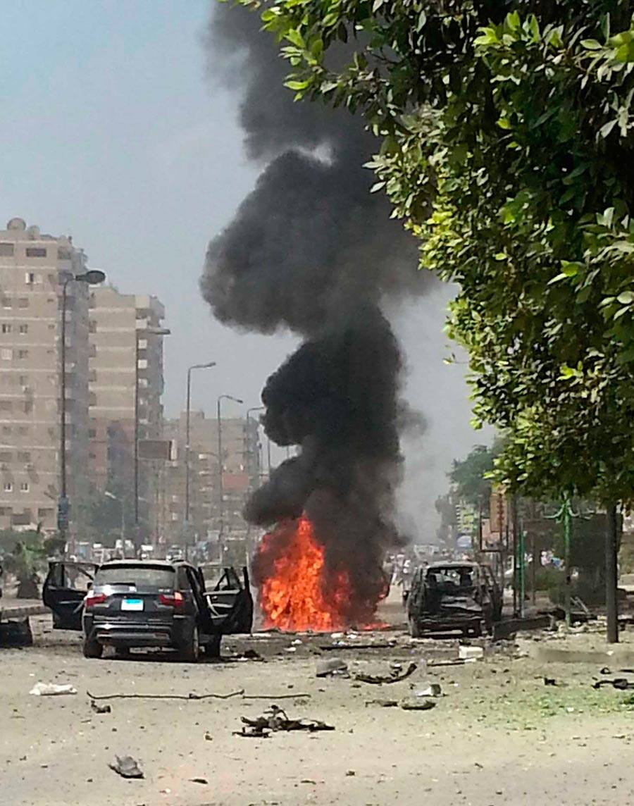 File photo, black smoke billows from a burning car moments after a bomb attack targeted the convoy of Egypt`s Interior Minister Mohammed Ibrahim, in Nasr City, Egypt, the first attack on a senior government official since a coup toppled the country`s Islamist president.