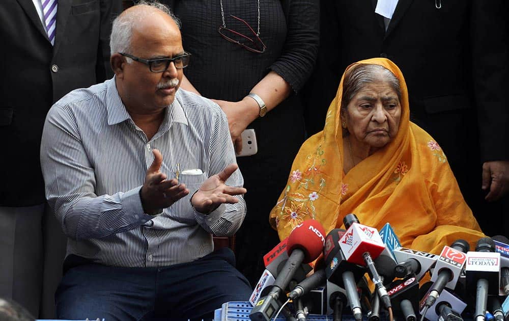 Zakia Jafri listens to her son Tanveer Jafri, son of former Congress lawmaker Ehsan Jafri, after a court ruling rejecting a petition seeking the prosecution of Bharatiya Janata Party leader Narendra Modi in Ahmedabad.