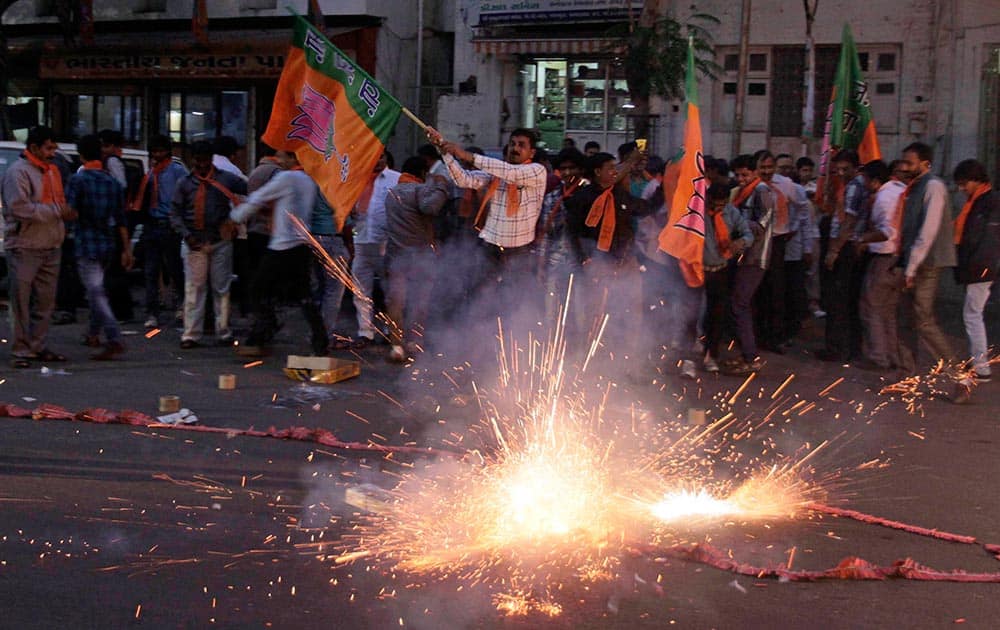 Supporters of India`s opposition Bharatiya Janata Party (BJP) celebrate after a court rejected a petition seeking the prosecution of Bharatiya Janata Party leader Narendra Modi in Ahmedabad.