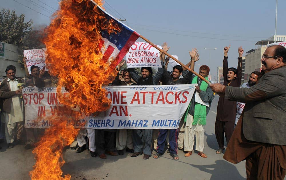 Pakistani protesters burn a representation of the U.S. flag to condemn American drone strikes on militants` hideouts in Pakistani tribal areas.