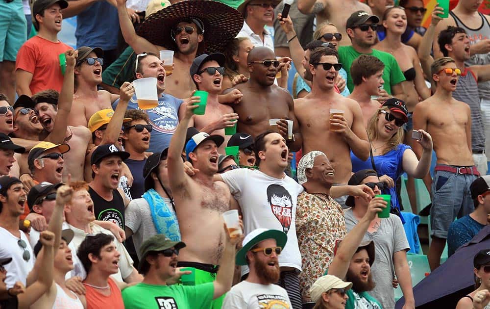 South African cricket fans sing during first day of their cricket test match between South Africa and India at Kingsmead stadium, Durban.