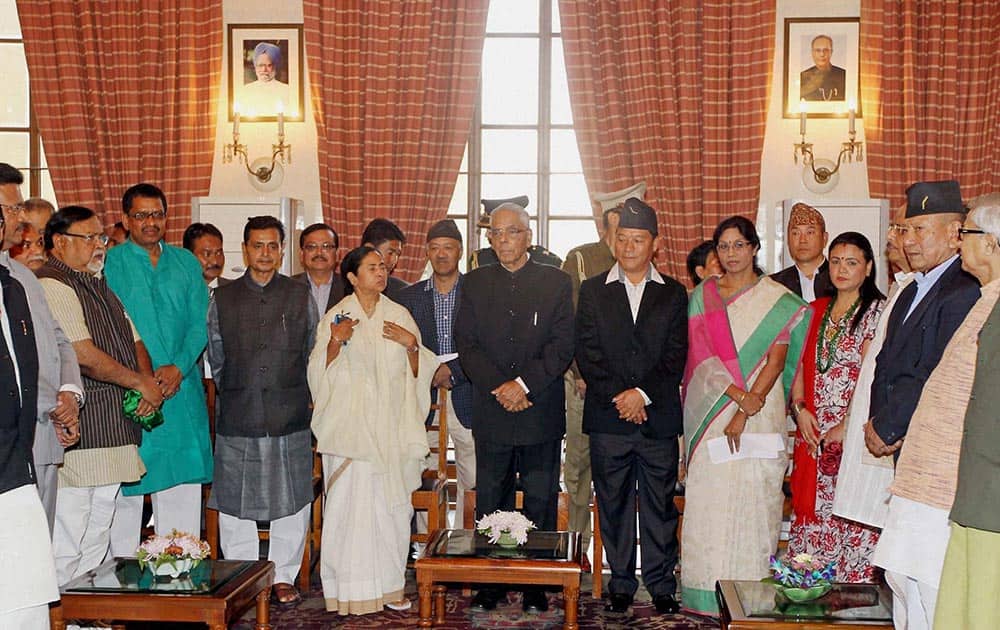 West Bengal Chief Minister Mamata Banerjee, State Governor M K Narayanan with Bimal Gurung, wife Asha Gurung and others after oath taking at Raj Bhavan in Kolkata.