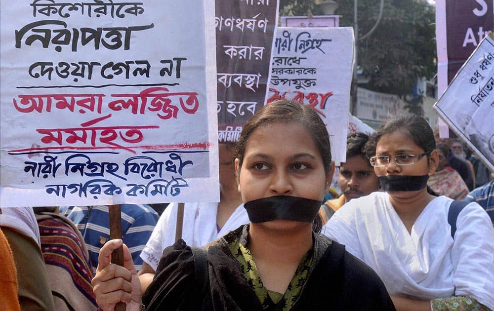 Women wear black ribbons to stage a silent protest against the state governemnt, demanding immediate action against rape and cases of sexual harrassment in Kolkata.