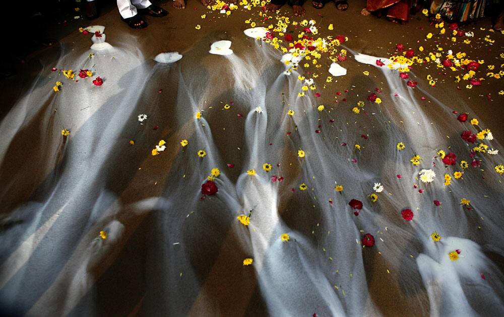 Indians offer milk during a prayer ceremony to commemorate the 9th anniversary of the 2004 Tsunami, on Marina beach, in Chennai, India. The Tsunami triggered by a magnitude-9.1 earthquake on Dec. 26, 2004 killed tens of thousands in 12 Indian Ocean nations.