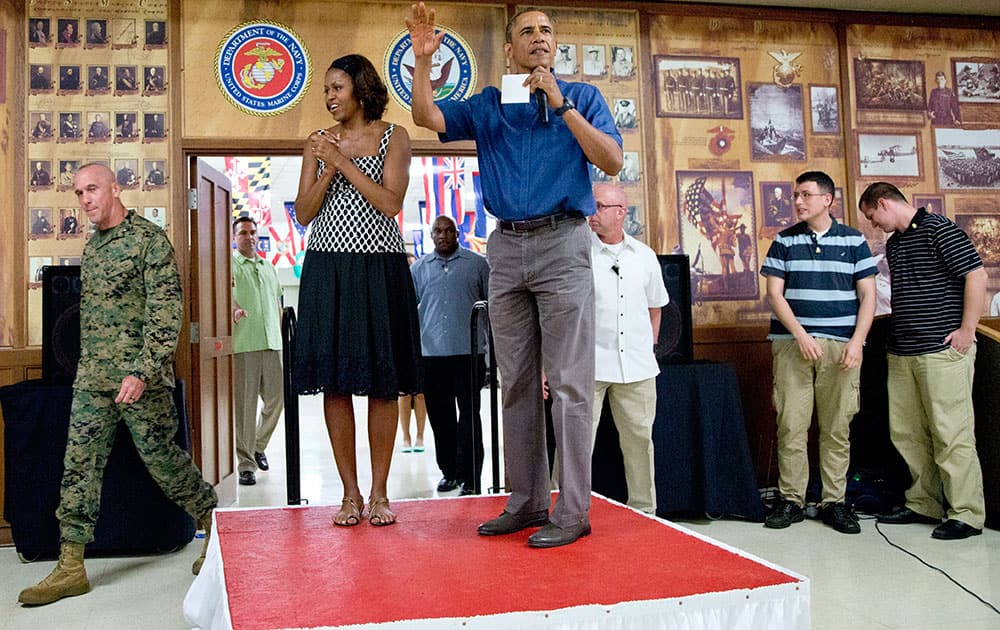 President Barack Obama and first lady Michelle Obama arrive to speak to members of the military and their families in Anderson Hall at Marine Corps Base Hawaii.
