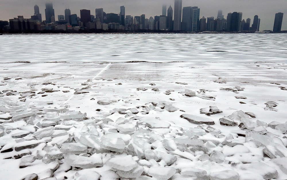 Snow-covered Lake Michigan is seen in Chicago. Two bursts of light snow are likely to total 1 to 2 inches area-wide, making this the snowiest Christmas in the Chicago area since 2002 when 2 inches fell.