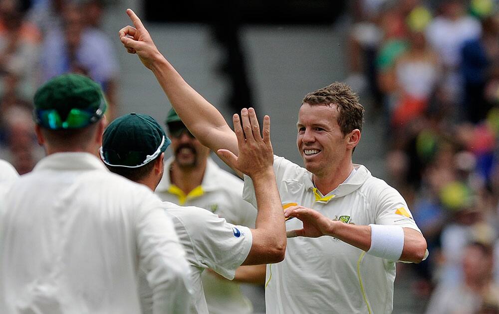 Australia`s Peter Siddle, right, celebrates the wicket of England`s Alastair Cook on the first day of their Ashes cricket test match, at the Melbourne Cricket Ground in Melbourne, Australia.