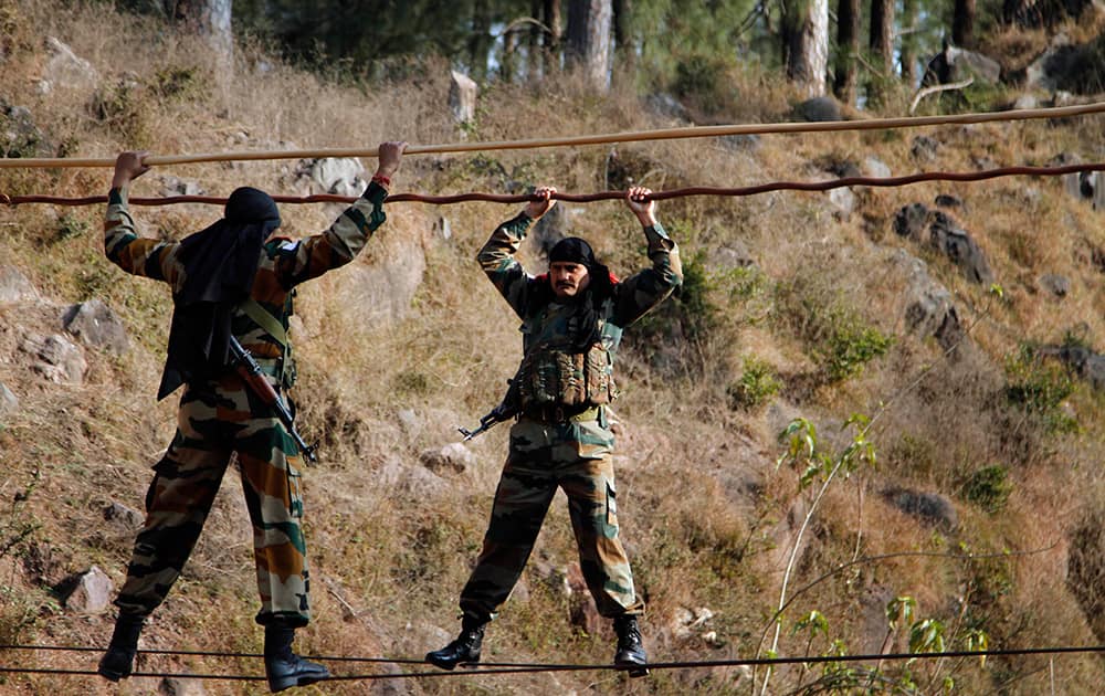 Indian army soldiers cross an obstacle course, during a training session at a battle school in Rajouri, about 138 kilometers (86 miles) northwest of Jammu.