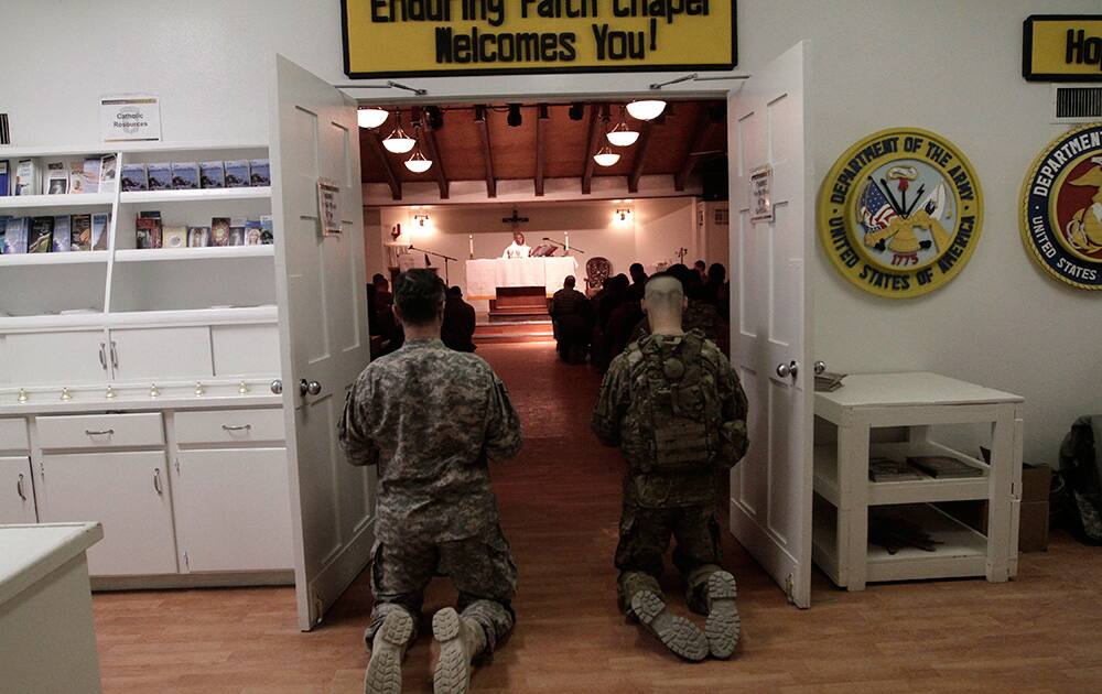 US soldiers and service members with the NATO- led International Security Assistance Force (ISAF) attend a religious ceremony on Christmas Eve at Bagram military base in Kabul, Afghanistan.