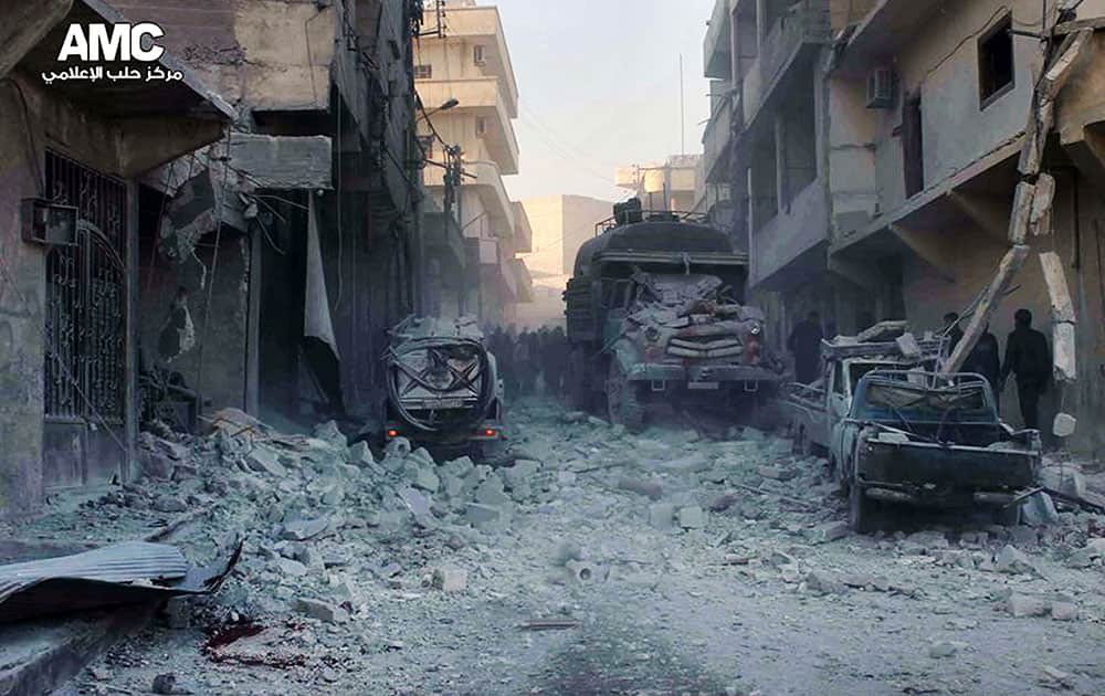 Citizen journalism image provided by Aleppo Media Center AMC, which has been authenticated based on its contents and other AP reporting, Syrians inspect damages buildings following a Syrian government airstrike in Aleppo, Syria.