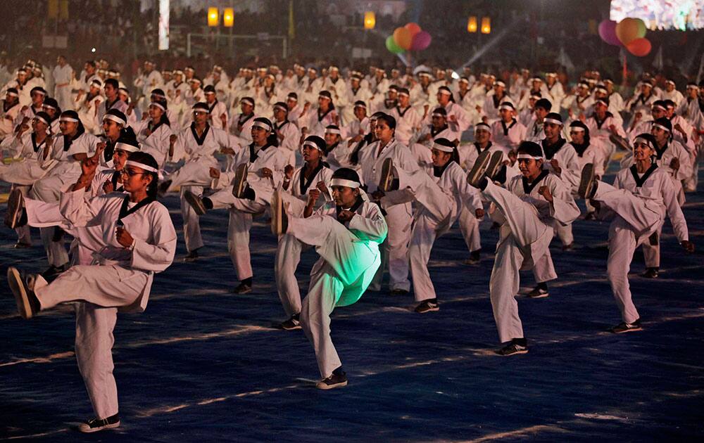 Indian girls display self defense skills during the closing ceremony of Khel Mahakumbh, or Sports Event in Ahmadabad.