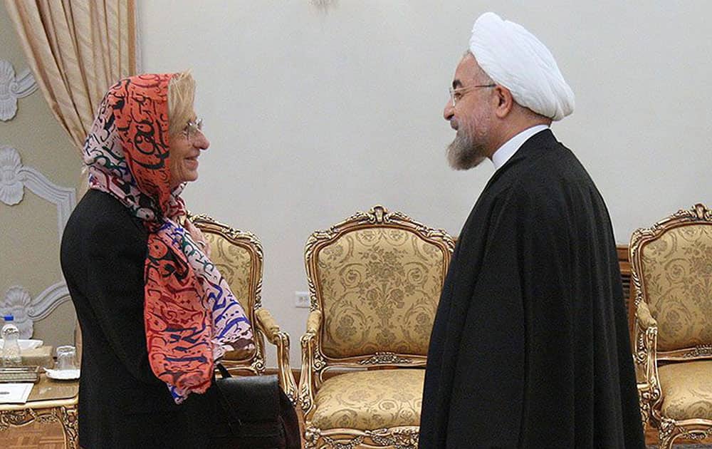 Iranian President Hassan Rouhani, right, welcomes Italian Foreign Minister Emma Bonino, for their meeting in Tehran, Iran.