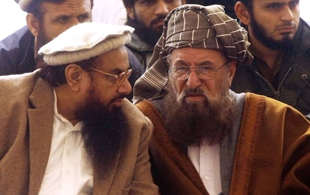 Hafiz Saeed talks to anti-US cleric Samiul Haq during a jirga or grand meeting, in Peshawar, Pakistan.