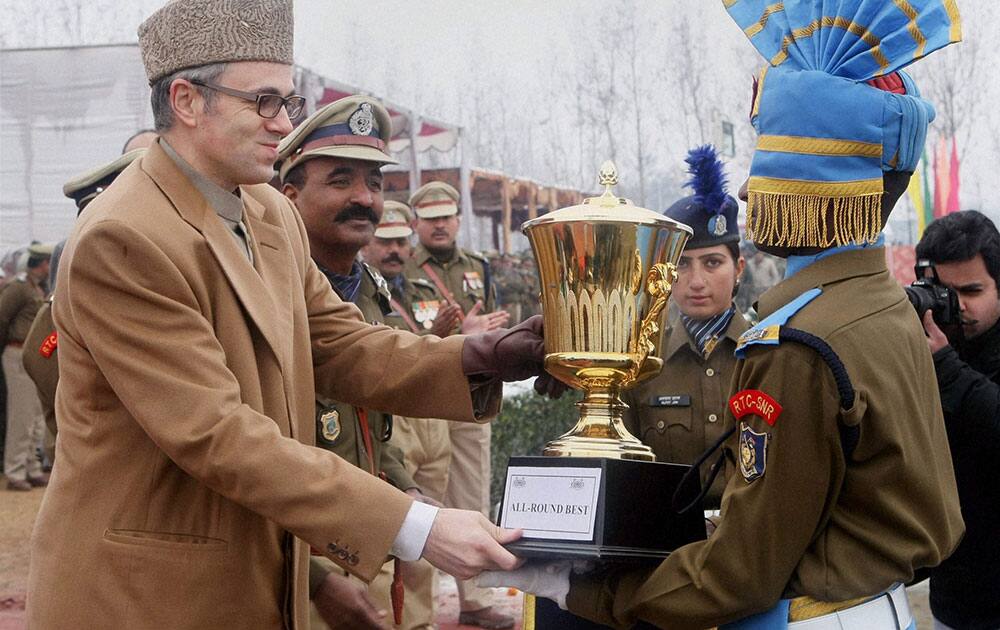 Jammu and Kashmir Chief Minister Omar Abdullah presenting the best all rounder trophy to Constable Sutender Kumar during CRPF`s attestation cum-passing out parade at Humhama in Srinagar.