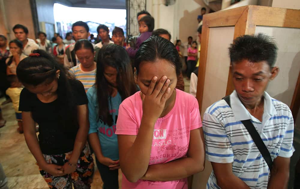 Typhoon survivors pray while attending a dawn Mass in anticipation of Christmas in Tacloban, Philippines. Many Filipinos attend nine consecutive dawn Masses before Christmas as part of traditional practice in this largely Roman Catholic nation.