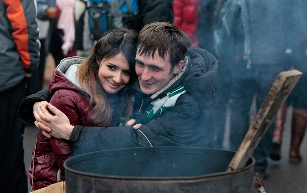 Pro-European Union activists warm themselves around a bonfire during the rally on Independence Square in Kiev, Ukraine.
