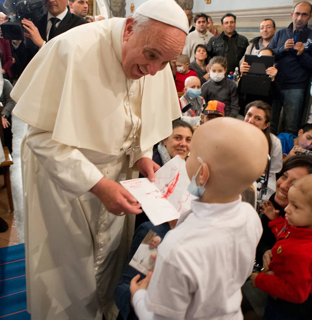 Pope Francis speaks with a child during his visit at the Bambino Gesu` pediatric hospital, in Rome.