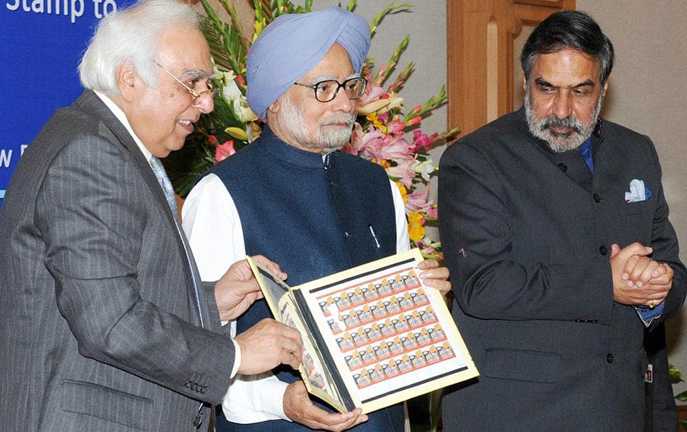 Prime Minister Manmohan Singh releasing the stamp on the occasion of the golden jubilee of IIFT, in New Delhi on Saturday. Also seen in the picture are Union Minister for Commerce & Industry, Anand Sharma and Union Minister for Communications & Information Technology and Law & Justice, Kapil Sibal.