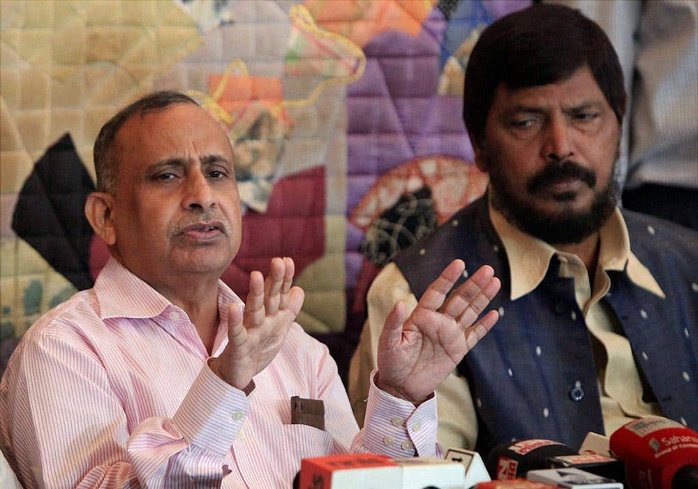 Diplomat Devyani Khobragade`s father Uttam Khobragade with Republican Party of India chief Ramdas Athavale during a press conference in Mumbai.
