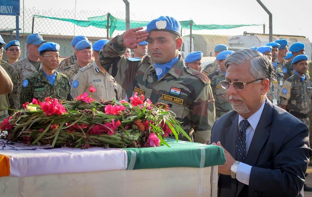 Indian Ambassador P. K. Bajaj lays flowers on the coffins of the two Indian peacekeepers who were killed on Thursday, at a memorial service held in the UNMISS compound in Juba, South Sudan.